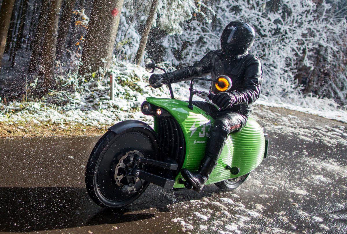 A Johammer electric motorcycle rides on a road near the Johammer e-mobility GmbH electric motorbike factory as snow falls in Bad Leonfelden, Austria, on Tuesday, Nov. 8, 2016. Photographer: Lisi Niesner/Bloomberg