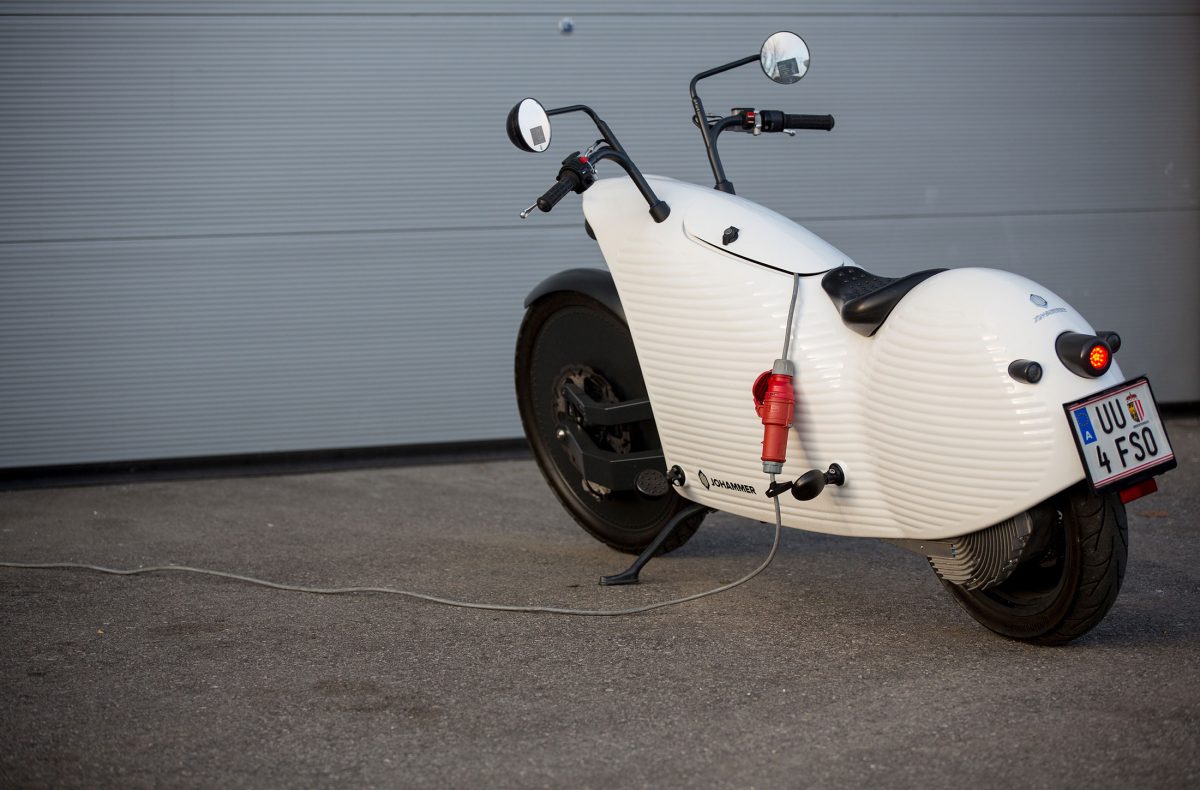 An electric charging cable sits connected to a Johammer electric motorcycle outside the Johammer e-mobility GmbH electric motorbike factory in Bad Leonfelden, Austria, on Tuesday, Nov. 8, 2016. Photographer: Lisi Niesner/Bloomberg